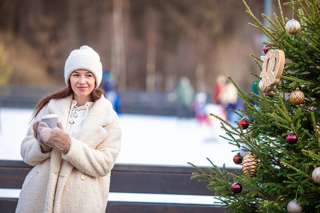 Smiling young girl skating on ice rink outdoors