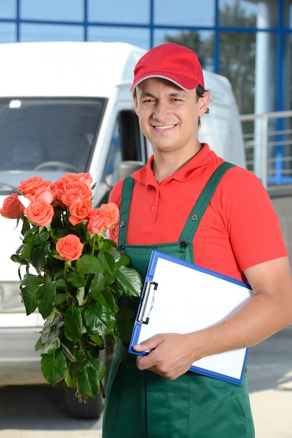 Smiling young male delivery courier man.