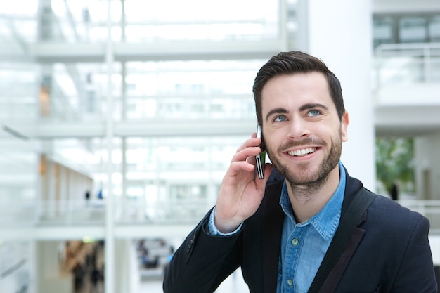 Smiling young man calling by phone