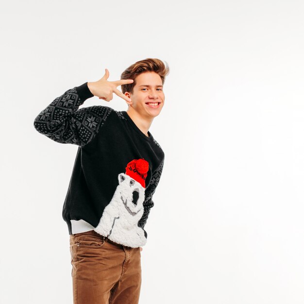 Smiling young man in cozy bear sweater on white background