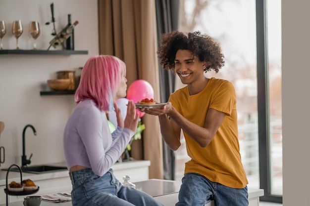 Smiling young man giving a present to his girlfriend