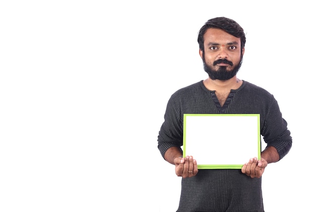 Photo smiling young man holding board isolated on white