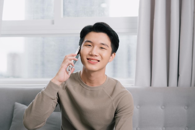 Smiling young man on the phone