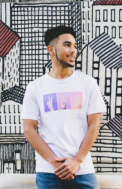 Smiling young man standing against wall