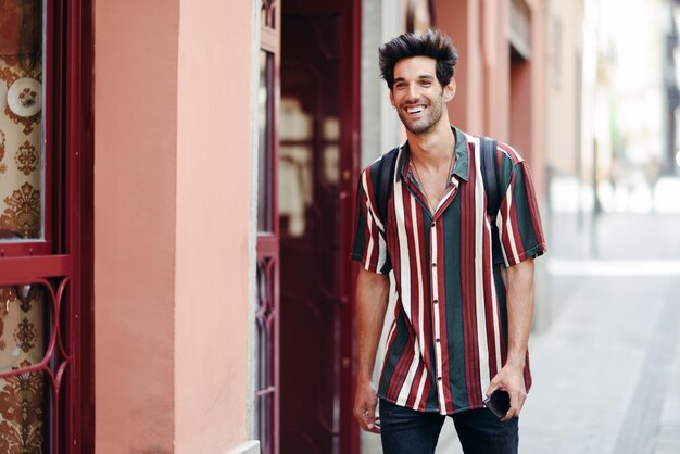 Smiling young man standing in city