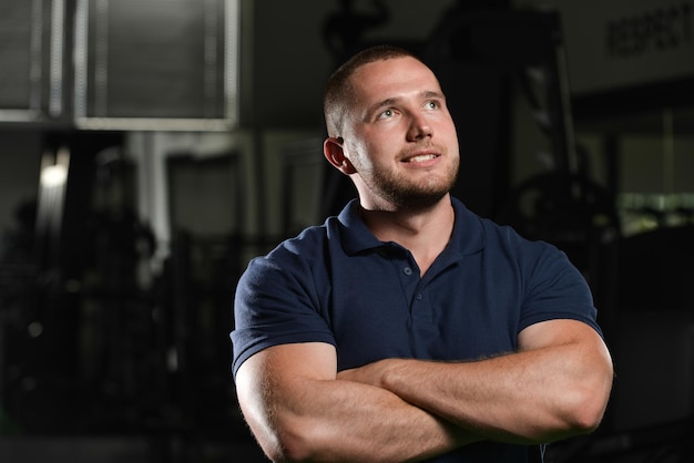 Smiling Young Man Standing With Arms Crossed