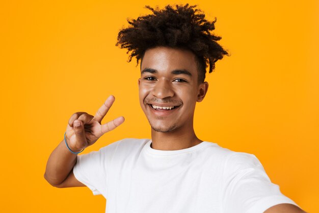 Smiling young man in t-shirt standing isolated