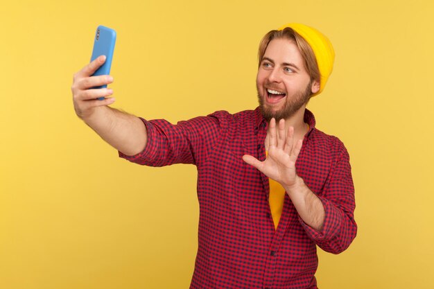 Smiling young man using mobile phone