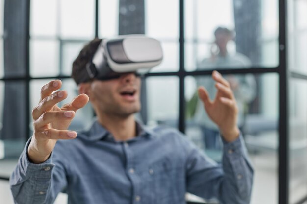 Smiling young man using virtual reality headset while sitting in office generative ai