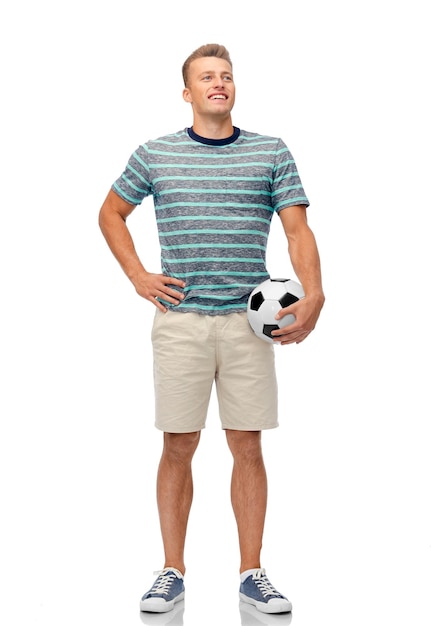 Photo smiling young man with soccer ball