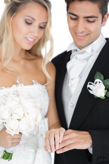 Smiling young married couple wearing wedding rings