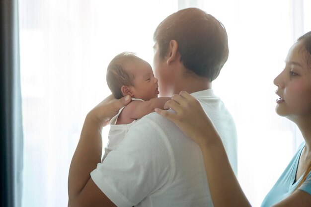 Photo smiling young mother and father with a new born baby family and love concept