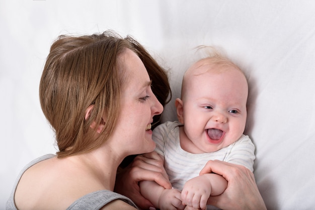 Smiling young mother with little baby. Portrait of happy mother with newborn