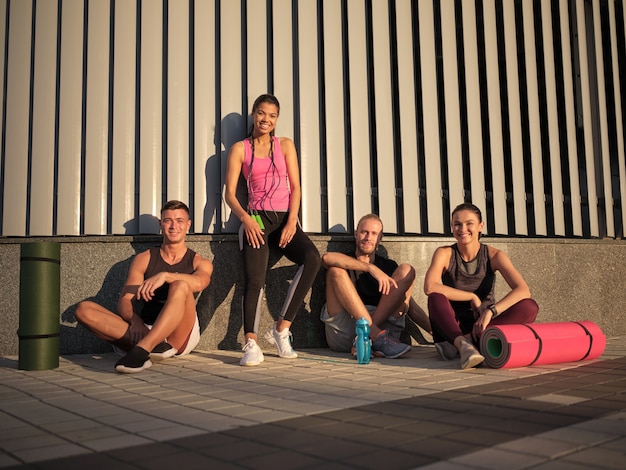 Smiling young multiracial sportive people after workout