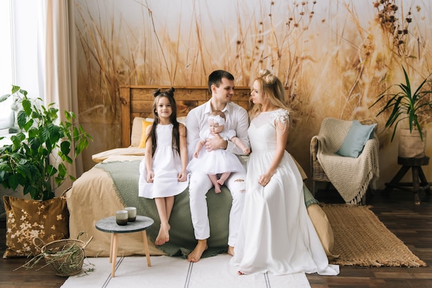 Smiling young parents and their two children