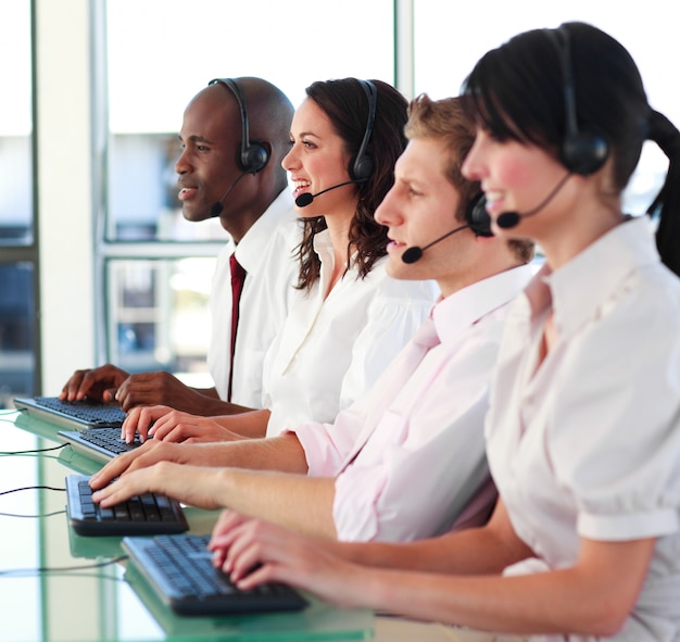 Smiling young people with a headset on working 