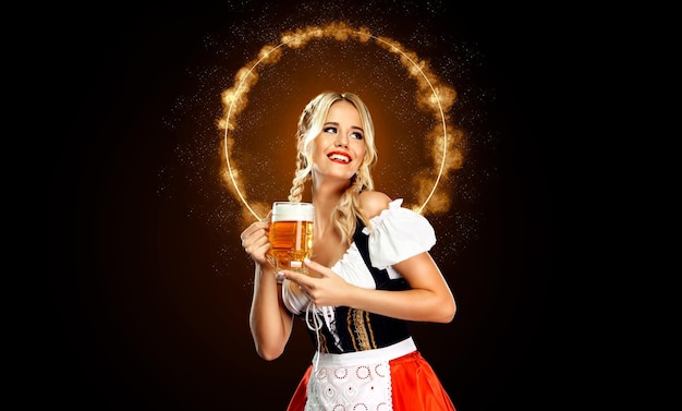 Smiling young sexy oktoberfest girl waitress wearing a traditional bavarian or german dirndl serving