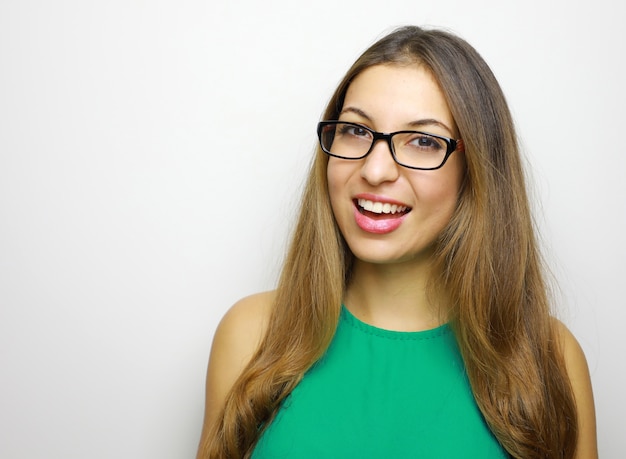 Smiling young woman in eyeglasses posing