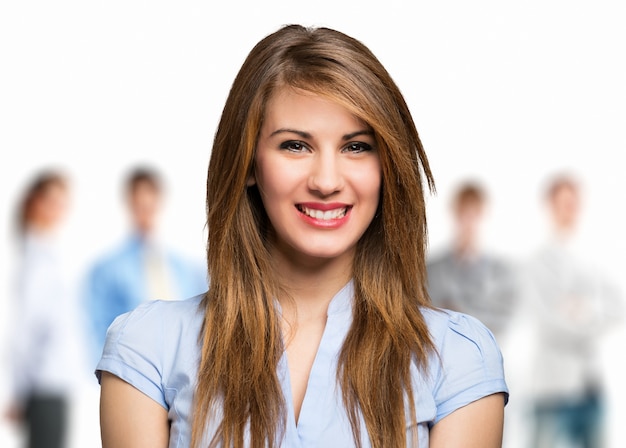 Smiling young woman in front of a group of people