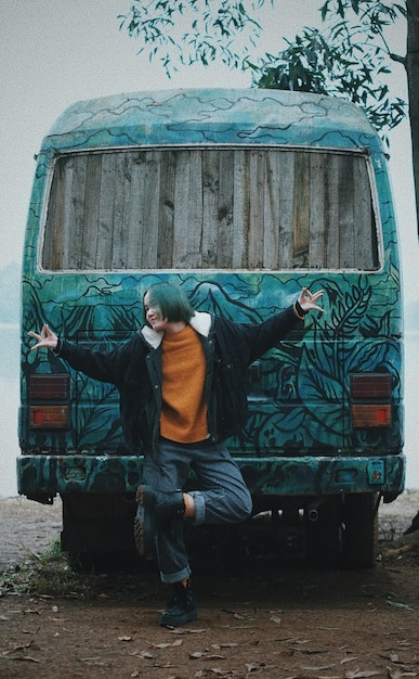 Photo smiling young woman gesturing against bus