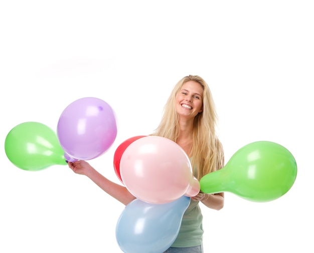 Smiling young woman holding balloons