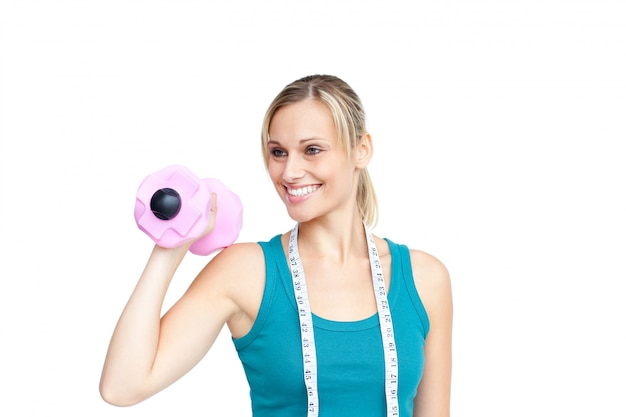 Smiling young woman holding dumbbells