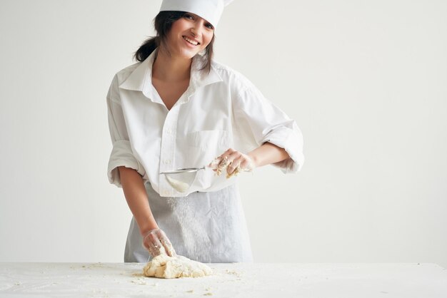 Smiling young woman holding ice cream against white background