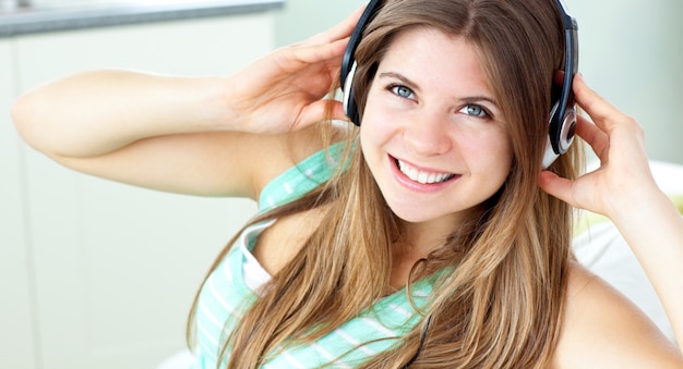 Smiling young woman listen to music 