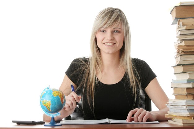 Photo smiling young woman looking away while sitting with stack of book against white background