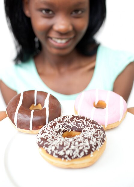 Smiling young woman looking at donuts 