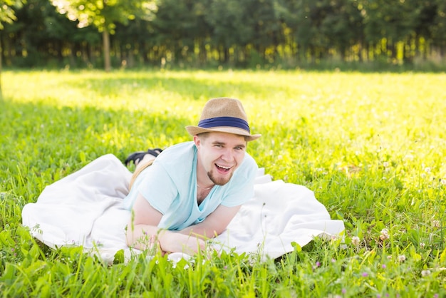 Smiling young woman lying on grassy field