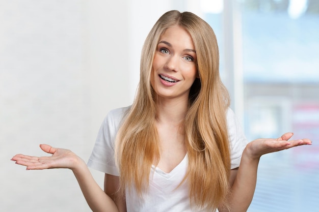 Smiling young woman pointing