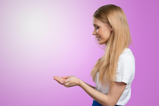 Smiling young woman pointing