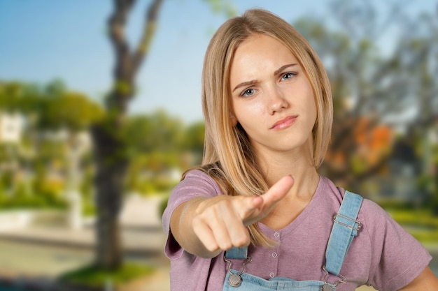 Smiling young woman pointing