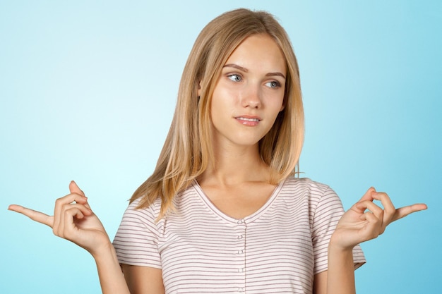 Smiling young woman pointing