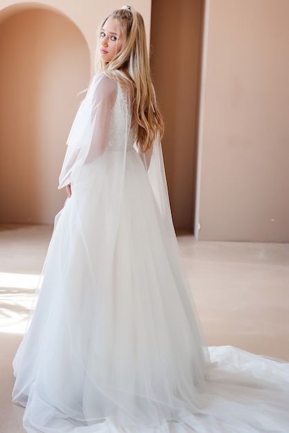 Smiling young woman posing in a wedding dress