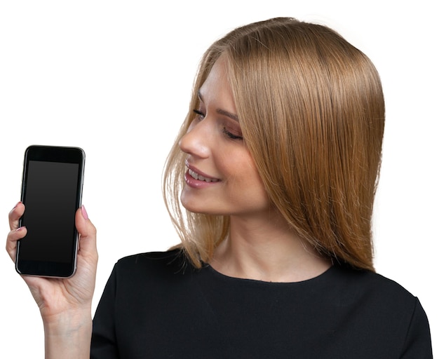 Smiling young woman showing blank smartphone screen