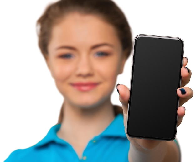 Smiling young woman showing blank smartphone screen