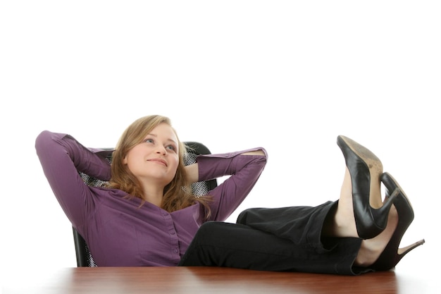 Photo smiling young woman sitting at desk against white background