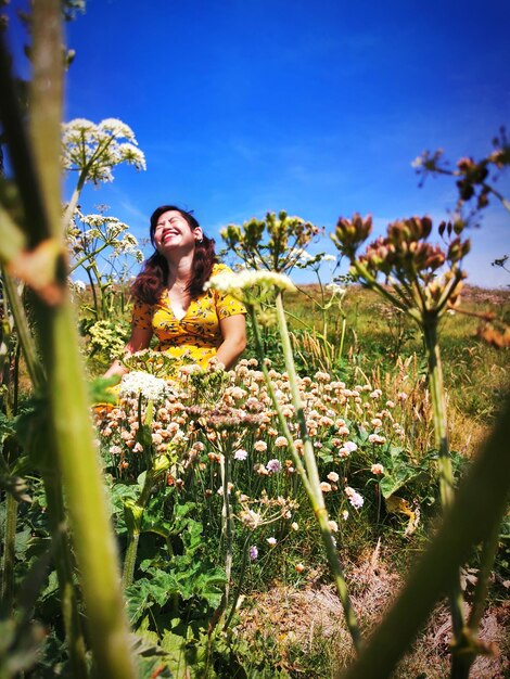 Smiling young woman sitting on field