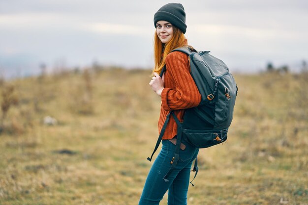 Smiling young woman standing on field