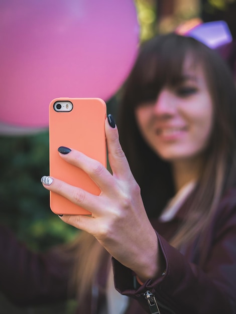 smiling young woman taking selfie