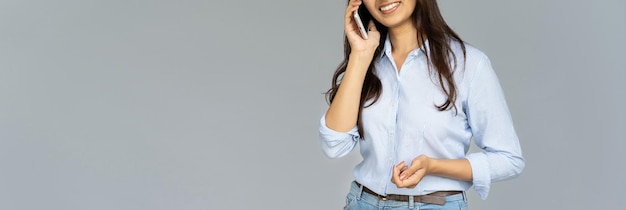 Photo smiling young woman talking on phone isolated on background banner