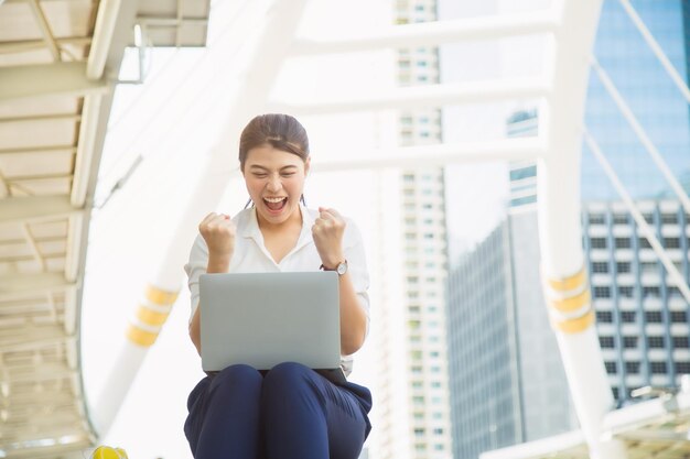 Smiling young woman using mobile phone