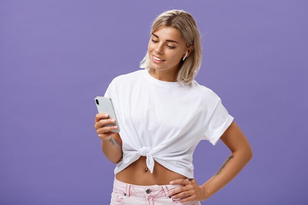 Smiling young woman using smart phone