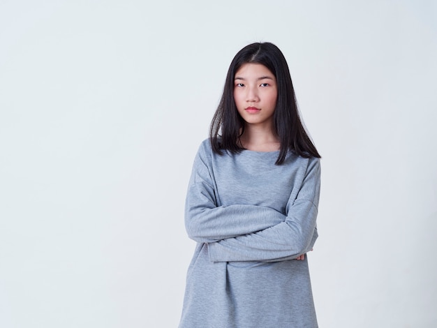 Smiling young woman over white wall