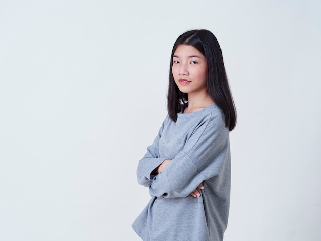 Smiling young woman over white wall