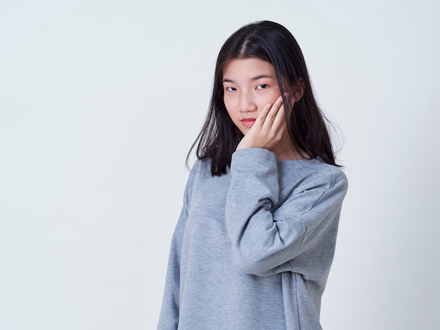 Smiling young woman over white wall