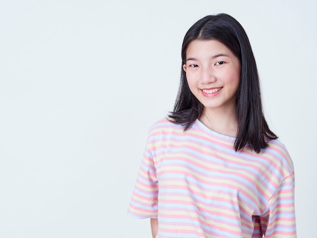 Smiling young woman over white wall