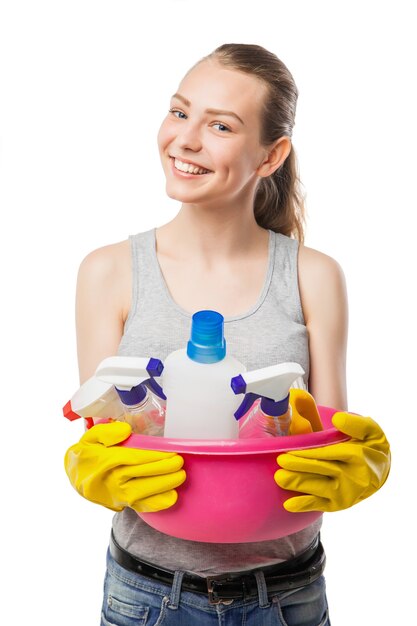 Smiling young woman with bowl of cleansers, close-up, housewife, isolated on white